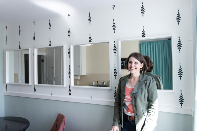 Fix a big blank wall with mirrors and wall decals like Seriously Happy Homes